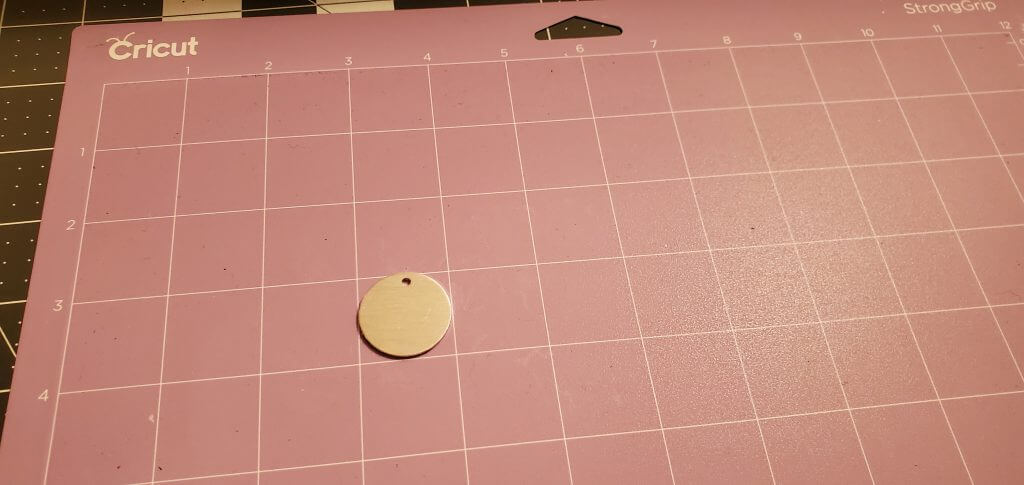 placing the aluminum blank onto the cricut strong grip mat