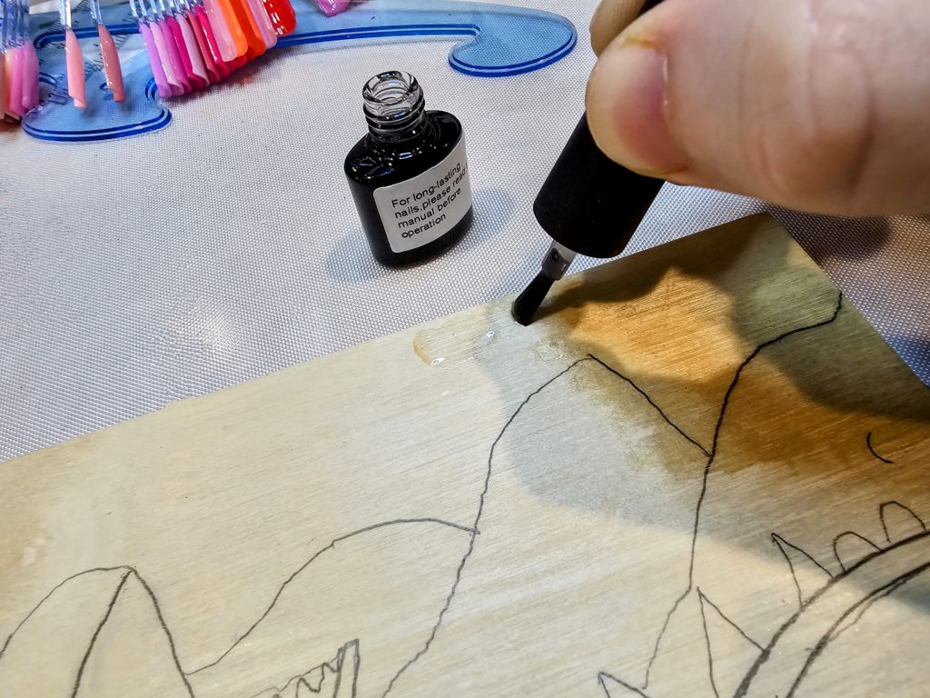 applying base coat to a wood painting panel